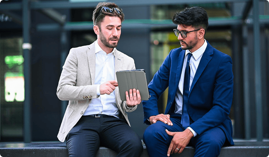 Two professionals consulting with a tablet